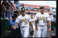 Oakland Athletics: 1990: Outfielder Jose of the Oakland Athletics (right) walks with his brother and teammate Ozzie Canseco. Mandatory Credit: Otto Greule Allsport